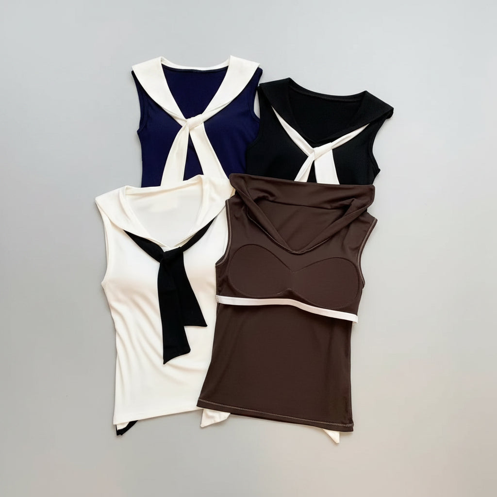 Brown sleeveless top with hood and white trim on a textured surface